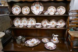 A quantity of Victorian floral tea ware and a three piece silver plated tea set