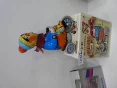 Group of tinplate toys to include a clockwork globe fairground ride and three others