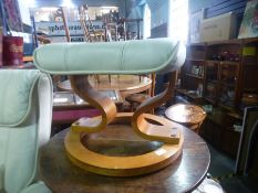 A leather recliner massage chair and footstool by Scotts of Stow; and a cane coffee table