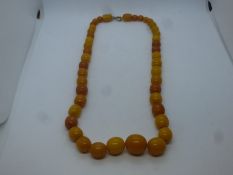 String of amber coloured beads with 9ct yellow gold clasp