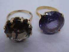Two 9ct yellow gold rings, set with large stones, one a smoky topaz and the other amethyst, one mark