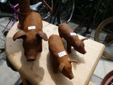 Three cast iron pigs