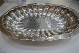 A large sterling silver oval tray of hammered design with reeded decoration, stamped 925, Mexico Alf