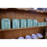 A quantity of old green kitchen canisters, by Bristol