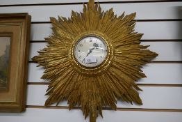 An old gilt sunburst wall clock 58cm