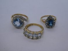 Three 9ct yellow gold dress rings, one set with circular pale blue stone in crossover setting, 9g ap