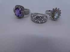 Three modern 9ct white gold dress rings to include pale blue and clear stone cluster example, size M