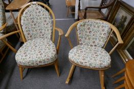 An Ercol light oak small open armchair and a small rocking chair, having a bow back