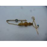 Three 15ct yellow gold brooches, one a bar brooch with possible aquamarine and safety chain on Victo