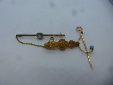 Three 15ct yellow gold brooches, one a bar brooch with possible aquamarine and safety chain on Victo