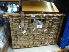 A wicker basket containing collectable and ephemera to include commemorative newspapers, shoe lasts,