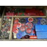 A wooden box containing  various vintage pieces of Meccano