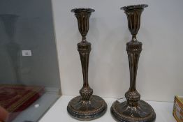 A pair of antique silver plated on copper candlesticks of Classical style
