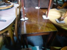 An antique mahogany gateleg table on pad feet
