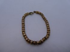 15ct yellow gold bracelet of intricate design starburst decoration, approx 20cm, clasp not gold, mar
