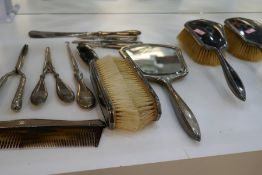 A quantity of silver and white metal items to include silver handled dressing table set, silver hand