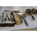 A quantity of silver and white metal items to include silver handled dressing table set, silver hand