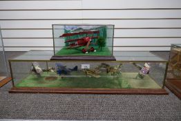 A glazed display of 5 military bi-planes probably Corgi and one other display of Fokker Red Baron