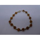 9ct yellow gold bracelet set with 15 circular polished amber stones, marked 9ct, 7.9 approx gross, 1