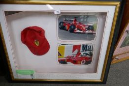 A framed baseball cap signed by Ferrari F1 Champion Michael Schumacher and Rubens Barrichello in 200