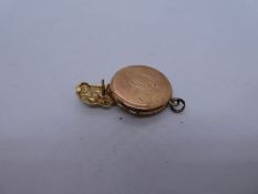 9ct yellow gold circular locket inscribed with initials and 9ct yellow gold badge in the form of a c