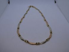 14ct two tone necklace, the links banana shaped, marked 585, to clasp, 44cm, 15.7g approx