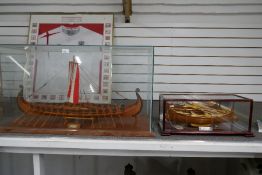 A wooden model of Viking Long Ship and a small model of Italian rowing boat, both in glazed cases, V