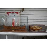 A wooden model of Viking Long Ship and a small model of Italian rowing boat, both in glazed cases, V