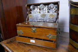 An antique oak Tantalus, having one drawer with brass decoration, 36.5cms