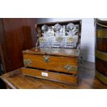 An antique oak Tantalus, having one drawer with brass decoration, 36.5cms