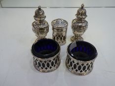 A pierced pair of two silver salts with Bristol blue inset, and a pair of decorative, pretty and orn