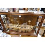 David Alan, a wooden model of HMS Bounty, one side showing a cutaway of the interior, in mahogany gl