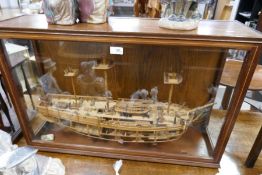 David Alan, a wooden model of HMS Bounty, one side showing a cutaway of the interior, in mahogany gl