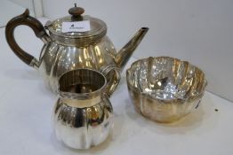 A heavy silver Edwrdian teapot of gadrooned design, not with a silver handle, hallmarked London 1904