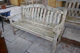 A solid large teak garden bench