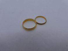 Two 22ct yellow gold wedding bands, size Q & M, both marked 22
