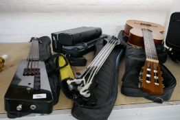 Two Ashbory bass electric guitars with soft cases, a modern acoustic guitar and other musical instru