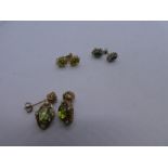 Three pairs of 9ct yellow gold earrings, one a pair cabochon peridot drop example, another a pair o
