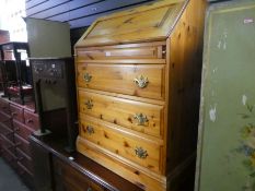 Waxed pine fitted bureau with 3 long drawers and an antique side table with a drawer