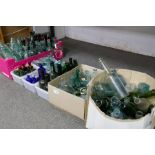 A large quantity of coloured and clear glass bottles, some 19th century
