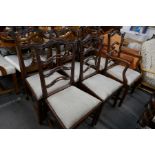 A set of 6 early 20th century mahogany dining chairs, 2 with arms, with wavy ladderback decoration