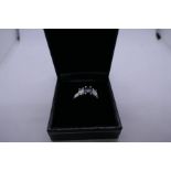 Pretty 18ct white gold trilogy ring set with central oval black diamond flanked two white diamonds,