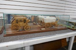 A glazed model of 19th century American wagon and stagecoach