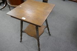 An early 20th century Oak two tier table having claw feet holding glass balls, 45.5cms