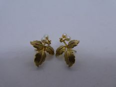 Pair of 9ct yellow gold leaf design earrings, each set with 2 seed pearls, marked 375, one back miss