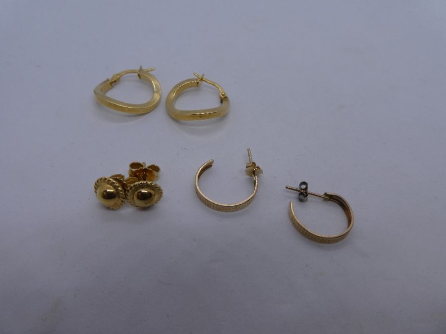 Two pairs of 9ct gold hoop earrings and a pair of 9ct gold studs, all marked, weight 3.5g approx