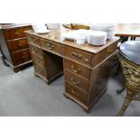 An old mahogany twin pedestal desk, having 9 drawers, 103cm