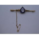 14K bar brooch set with a tear shaped amethyst, 6.4g approx, 6cm, with safety chain, marked 14K