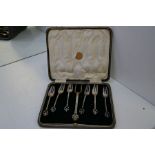 A cased set of six silver cake/pastry forks and two other forks for serving, with pierced heart desi