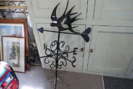 A wrought iron weather vane, decorated swallows 107.5cm